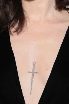 a woman with a cross tattoo on her chest