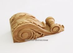 a carved wooden object on a white background