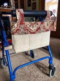 a blue walker with a quilted bag on it's handlebars in a living room