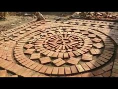 a circular design made out of bricks on the ground