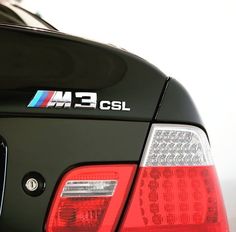 the back end of a black bmw car with m - 3 logo on it's tail