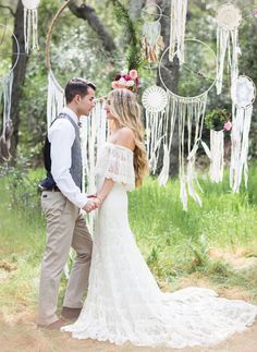 a man and woman standing next to each other holding hands