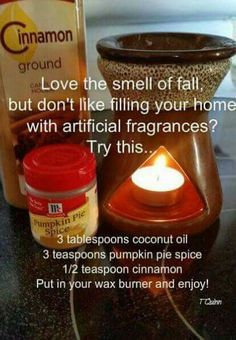 a candle and some jars on a table with information about cinnamon spice in front of it