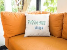 an orange couch with a white pillow that says passeonante aluvia on it