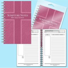 a spiral bound notebook with pink paper on the front and back cover, sitting next to a