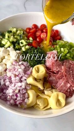 the ingredients for this pasta dish are being poured into a bowl