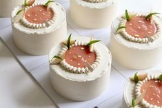 several small cakes sitting on top of a white counter