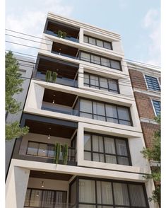 an apartment building with balconies on the second floor