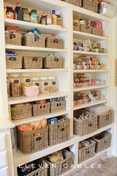 an organized pantry with wicker baskets, food and other items on shelving units