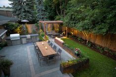 an outdoor dining area is lit up at night with candles on the table and chairs