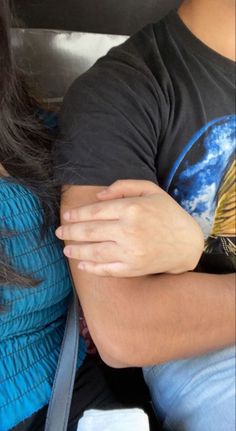 a person with their arm wrapped around another persons shoulder