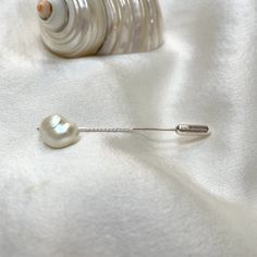 A gorgeous 11mm x 9mm baroque pearl tie pin. This naturally iridescent freshwater pearl has a soft sheen ivory lustre with hints of pink and blue gleaming, making it perfect to wear with many colours.  The 4cm long sterling silver pin has a twist half way along its lengh and  easy use push on protector which adds just a little to the overall length.  A smart addition to any man's jewel box. Tie pins are the perfect gift for men, groomsmen and best men, gentlemens' cravats, ties, and lapels. Pear Elegant Silver Lapel Pin For Groom, Formal Silver Pearl Brooch, Elegant Pearl Brooches For Formal Occasions, Elegant White Lapel Pin For Wedding, Classic Silver Wedding Pins, White Pearl Brooches For Formal Occasions, Formal White Pearl Brooches, Classic White Lapel Pin For Formal Occasions, Elegant White Pins For Formal Occasions