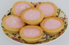 small pink desserts are on a floral plate