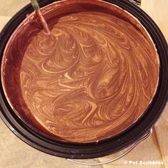 a chocolate cake in a black pan with a green straw sticking out of the top