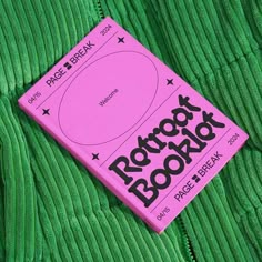 a pink book laying on top of a green jacket with the words rock'n'roll written on it