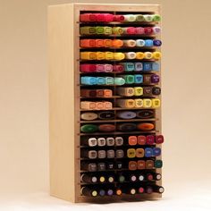 a wooden box filled with lots of different colored crayons on top of it