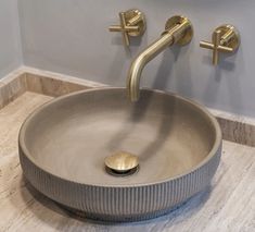 a bathroom sink with two faucets on the wall