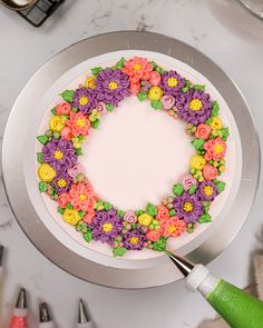 there is a cake decorated with flowers and icing on the plate, ready to be cut