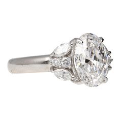 an oval cut diamond ring with three pear shaped diamonds