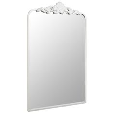 a white mirror sitting on top of a wall