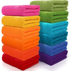 a stack of bright colored towels sitting next to each other on top of a white surface