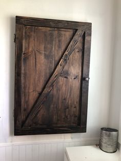 an old door is hanging on the wall