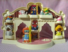 there is a toy doll house with toys in it