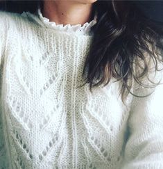 a close up of a person wearing a sweater