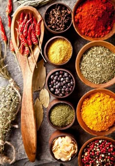 several bowls filled with different types of spices