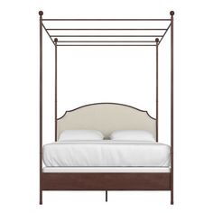 the canopy bed is made up with white sheets and pillows