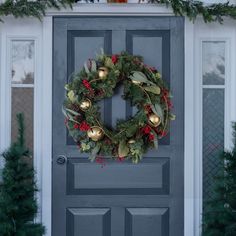 a christmas wreath on the front door of a house