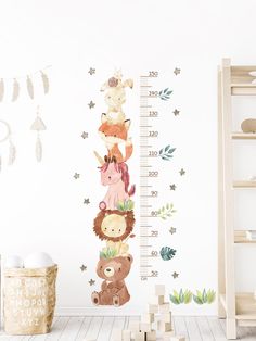 a child's growth chart with animals and stars on it, next to a teddy bear wall sticker