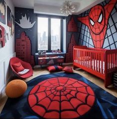 a bedroom decorated in red and black with a spiderman theme