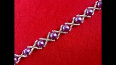 a bracelet with purple pearls and silver beads on a red background, close - up