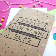 a new year's card with the words happy new year on it and confetti sprinkles