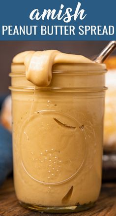 a jar filled with peanut butter spread on top of a wooden table