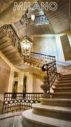 stairs and chandelier in the lobby of a building with text overlaying it