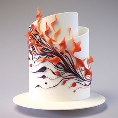 a white cake with orange and black designs on it