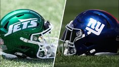 two football helmets sitting on top of a field