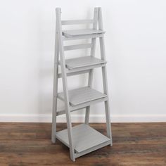 a ladder shelf sitting on top of a wooden floor