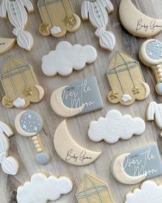 decorated cookies are arranged on a table with the words give me the moon written on them