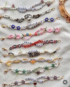 a bunch of beads that are sitting on a white table cloth next to a mirror