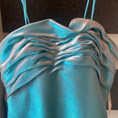 the back of a blue dress on display