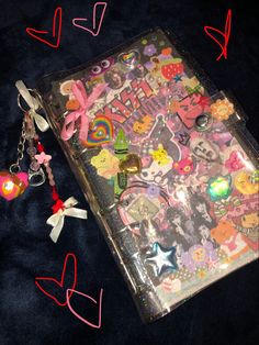 an open suitcase with lots of stickers and charms on the inside, along with other items