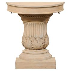 an old white marble pedestal with carvings on the top and base, isolated against a white background