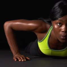 a woman is doing push ups on her stomach