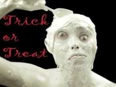 a white statue with the words trick or treat on it's face and hands