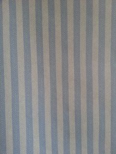 a blue and white striped wallpaper with vertical stripes on it's surface,