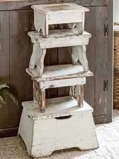 a stack of wooden stools sitting on top of a rug