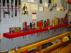 many different types of lighters are hanging on the wall in a shop or workshop